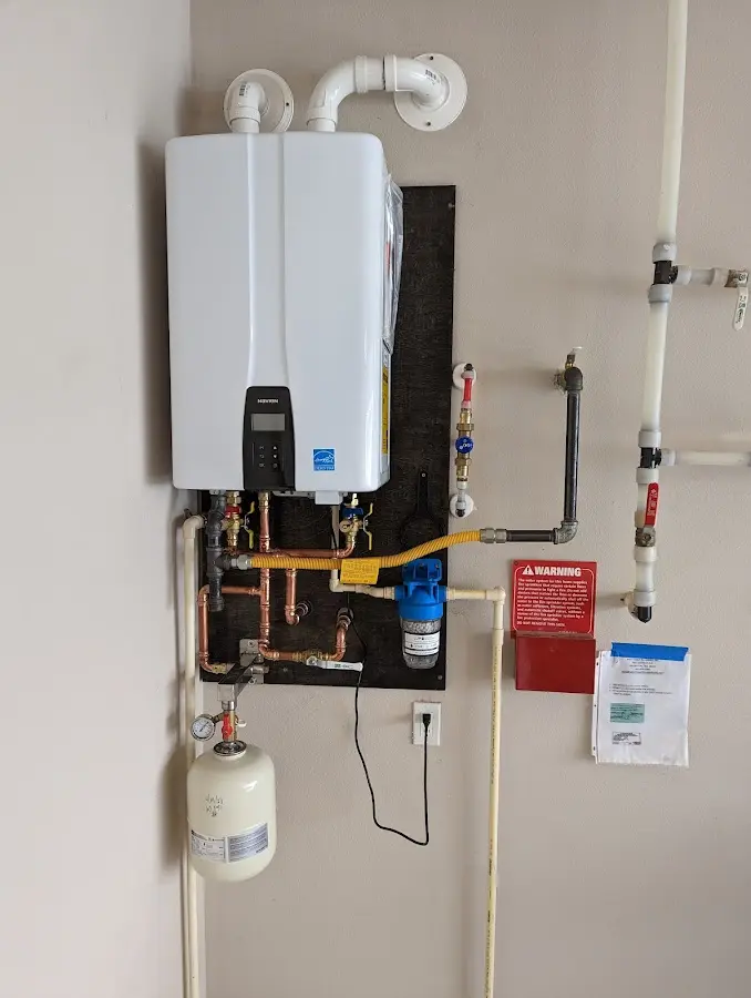 Professional plumber installing copper piping in a North Hills home